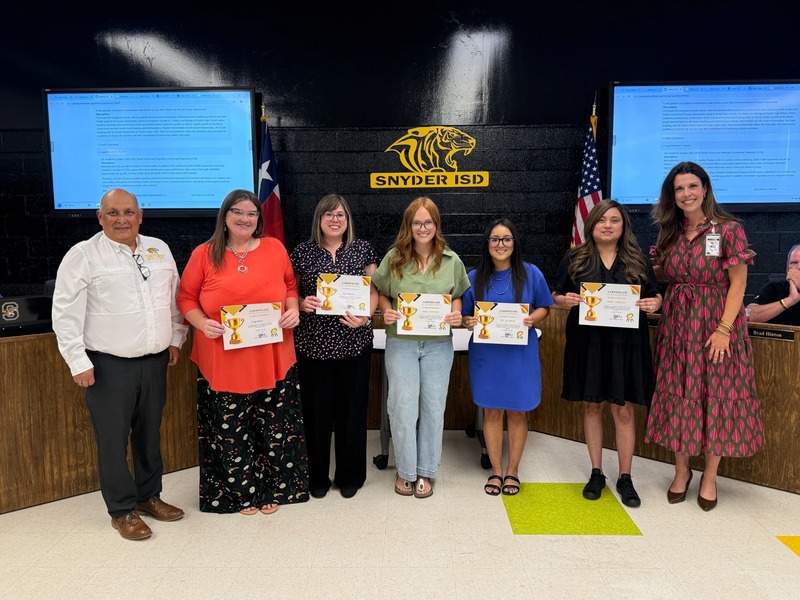 staff and students posting with certificates