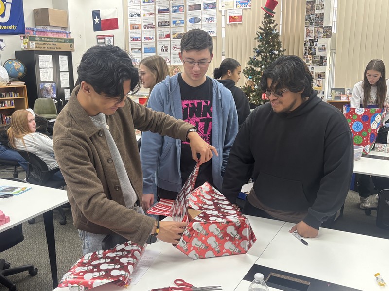 students wrapping a present