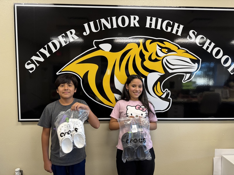 students posing with shoes