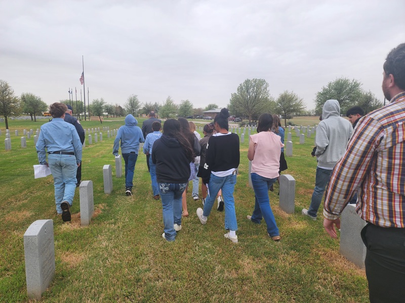 students walking through cemetary