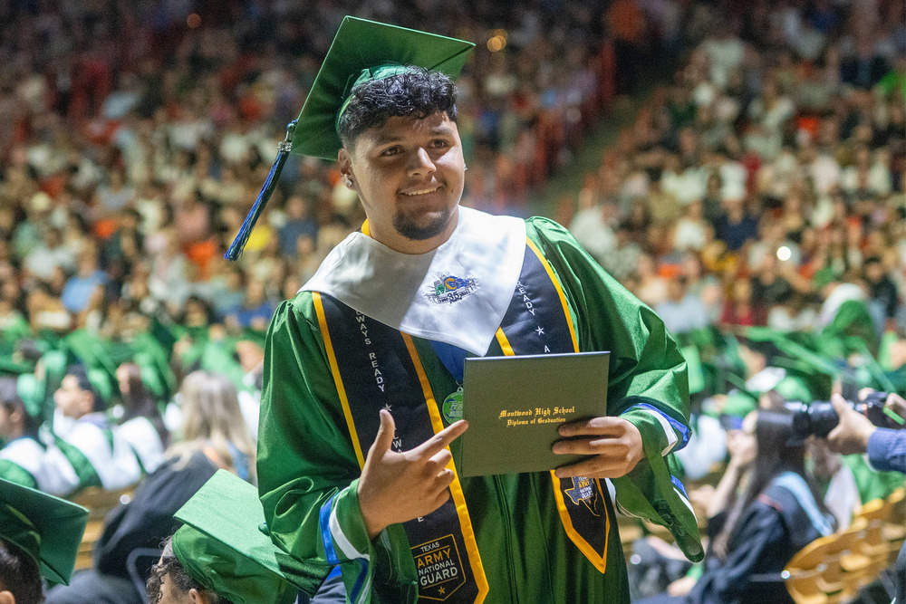 Graduate holding diploma