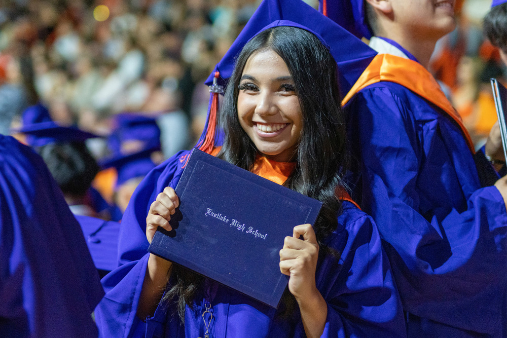 Graduate holding diploma