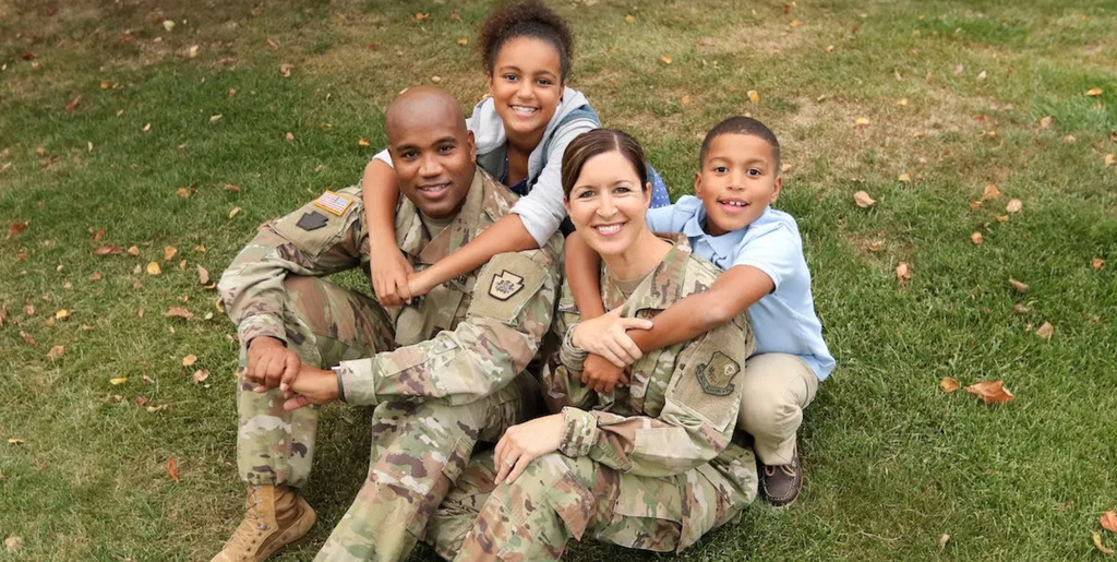 SISD military family smiling together as they hug