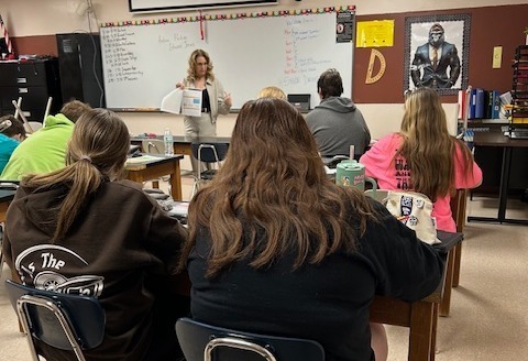 adult presenting to a class of students