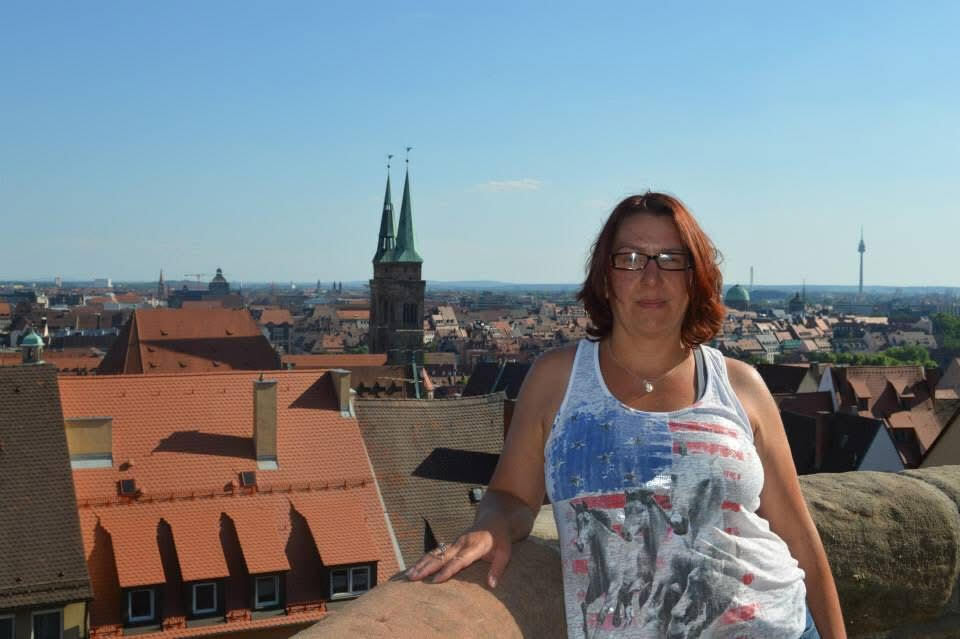 Tina rollins standing on a balcony with the the city skyline of Nurnberg, Germany