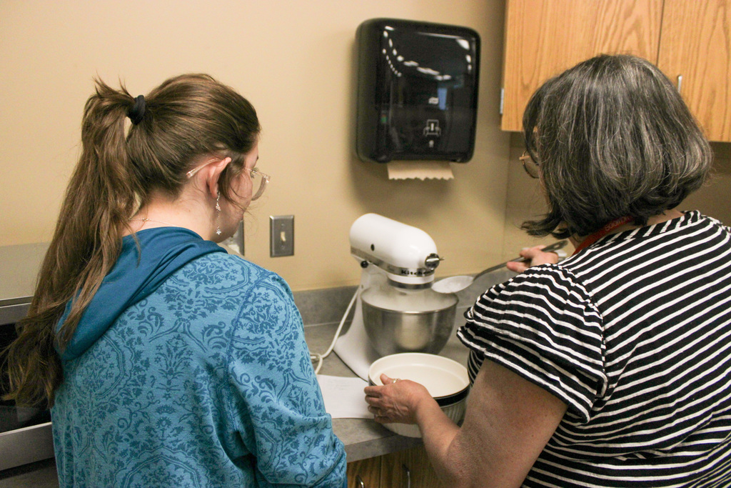 Vinson assisting students in culinary class