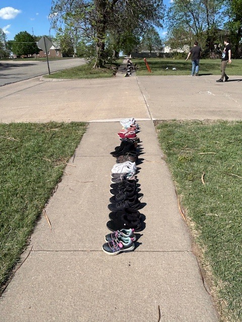 shoes lined up along sidewalk
