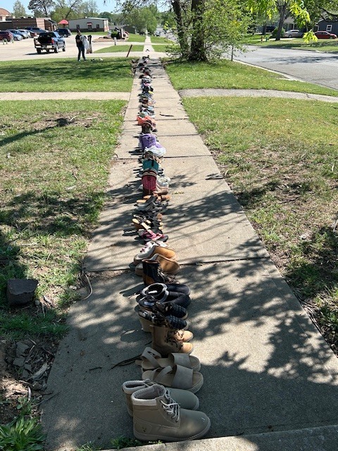 shoes lined up along sidewalk