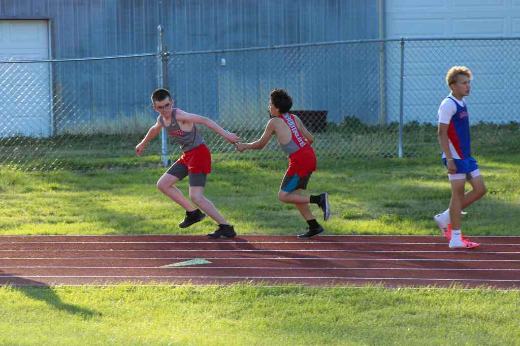 students in relay race passing the baton