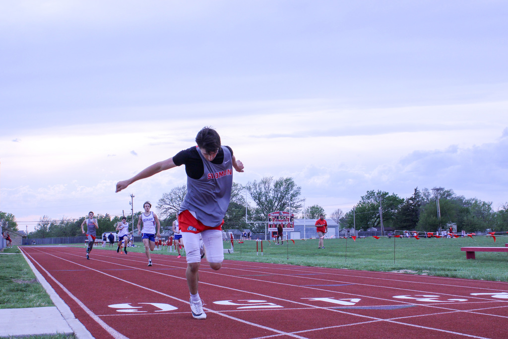 student finishing up a race and pushing toward the finish line