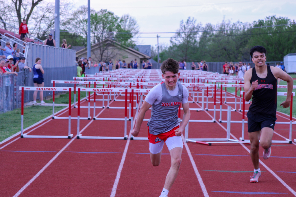 solomon student racing toward the finish line in hurdles