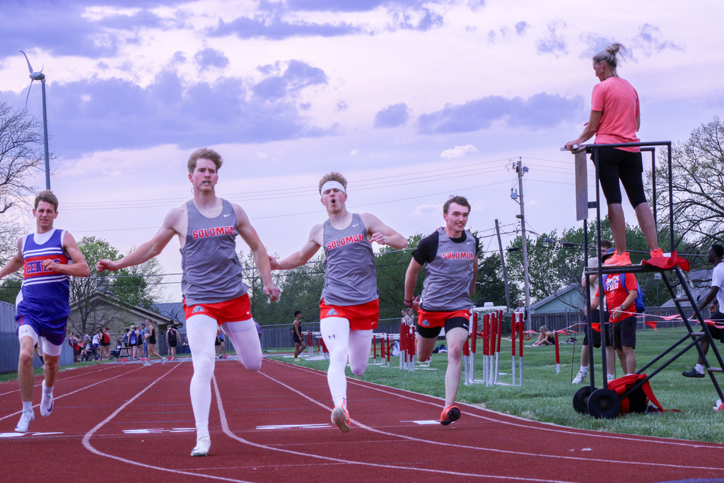 three solomon students finishing up a race 