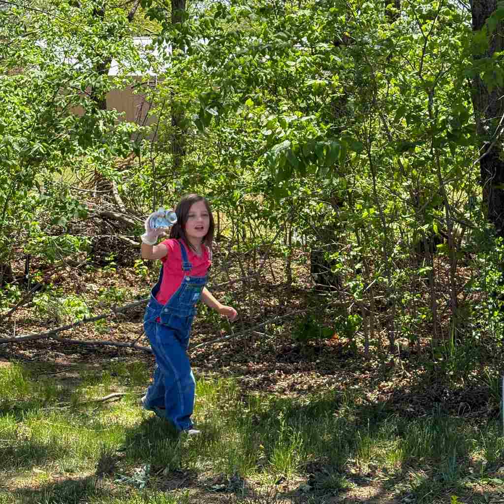 group of students cleaning up school grounds