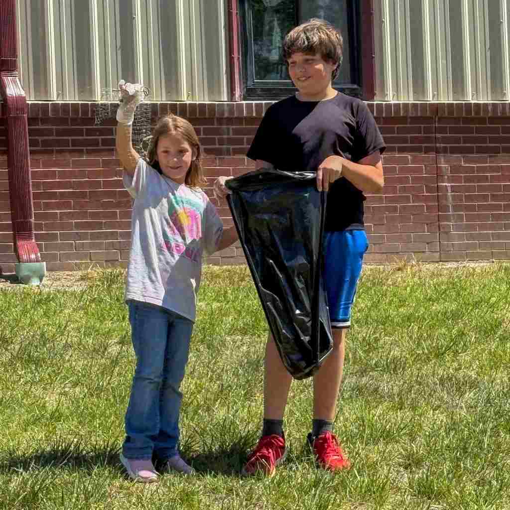 group of students cleaning up school grounds