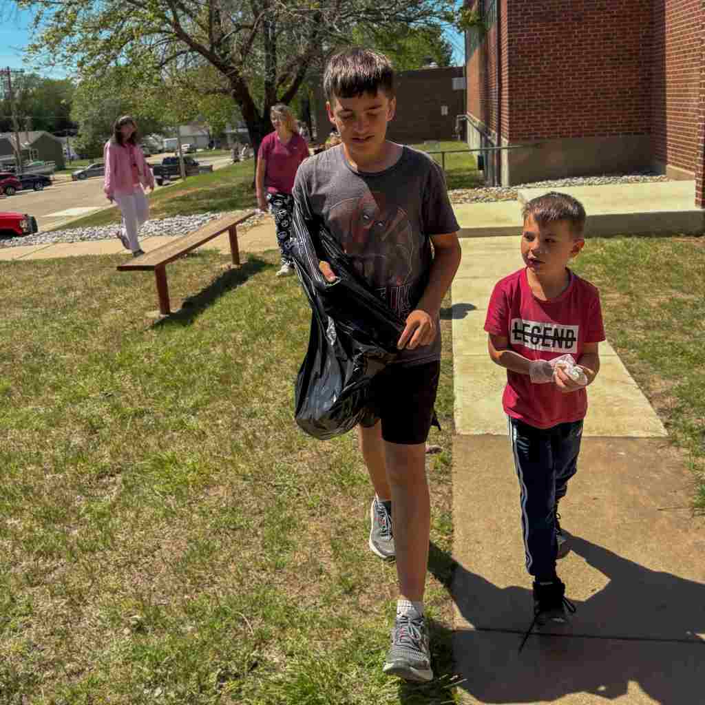 group of students cleaning up school grounds