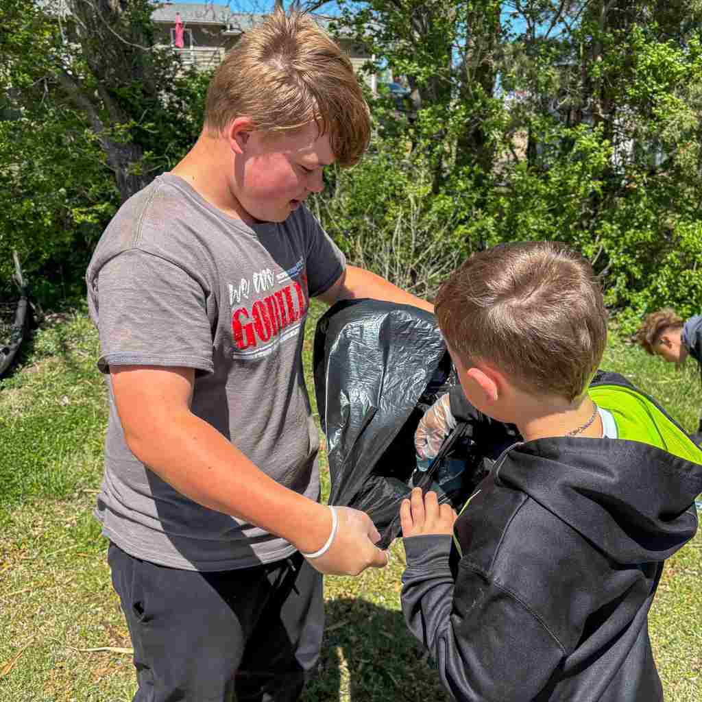 group of students cleaning up school grounds