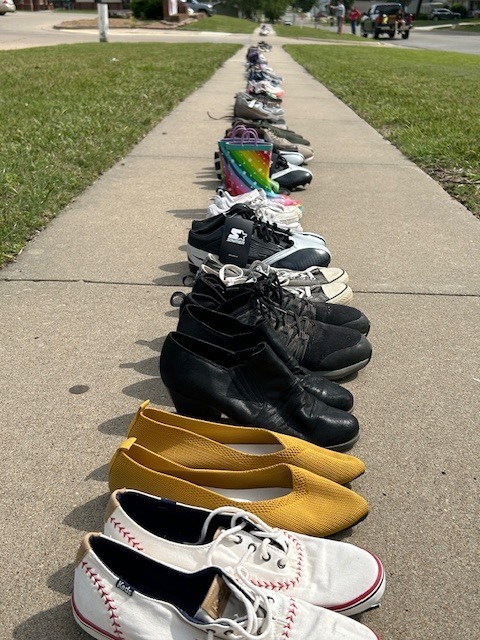 shoes lined up along sidewalk