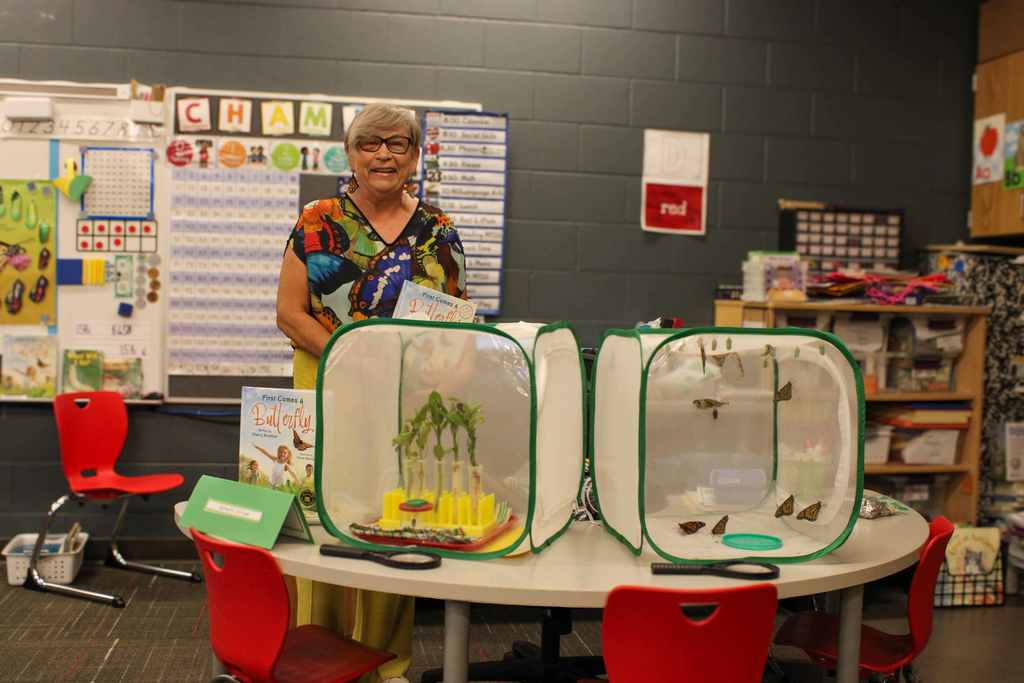 Sherry Kriebhel posing with butterfly cages