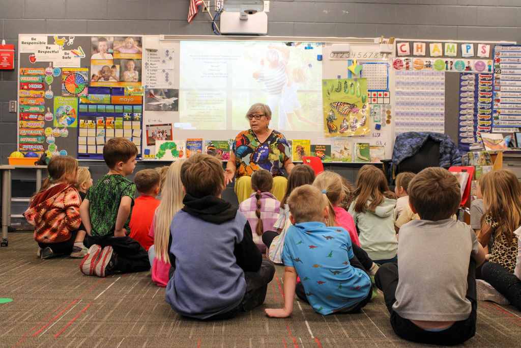 Sherry reading and talking to a group of students