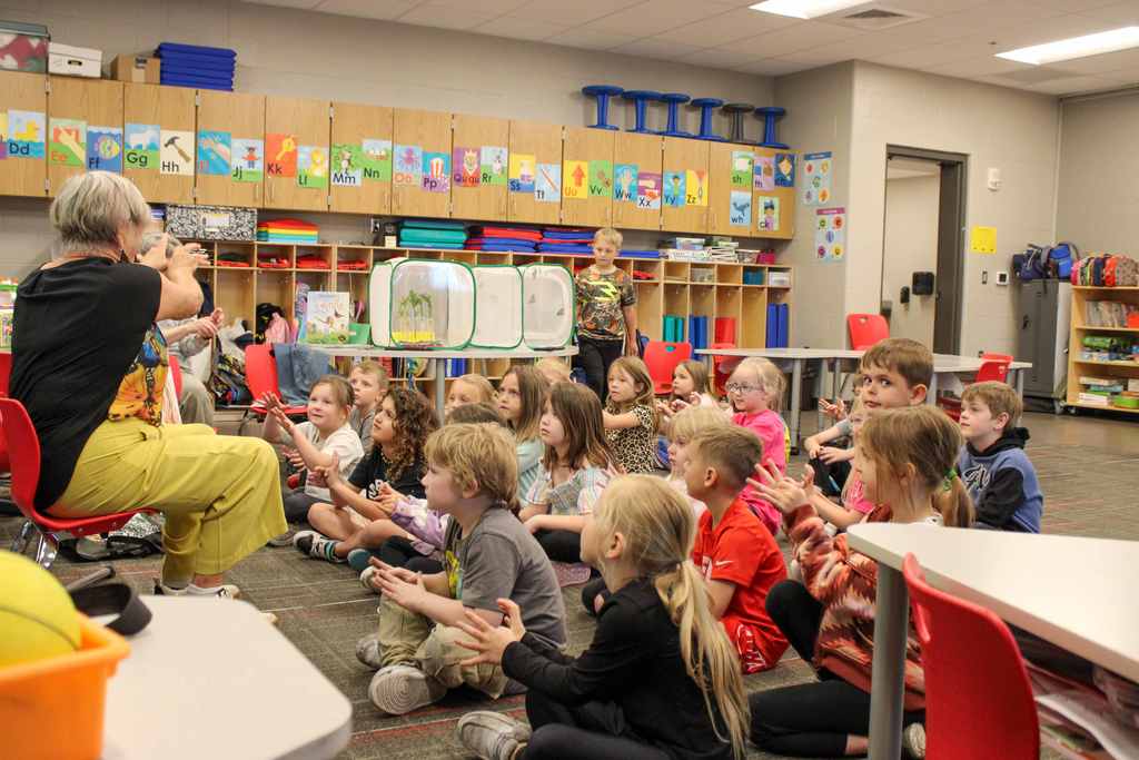 Sherry reading and talking to a group of students