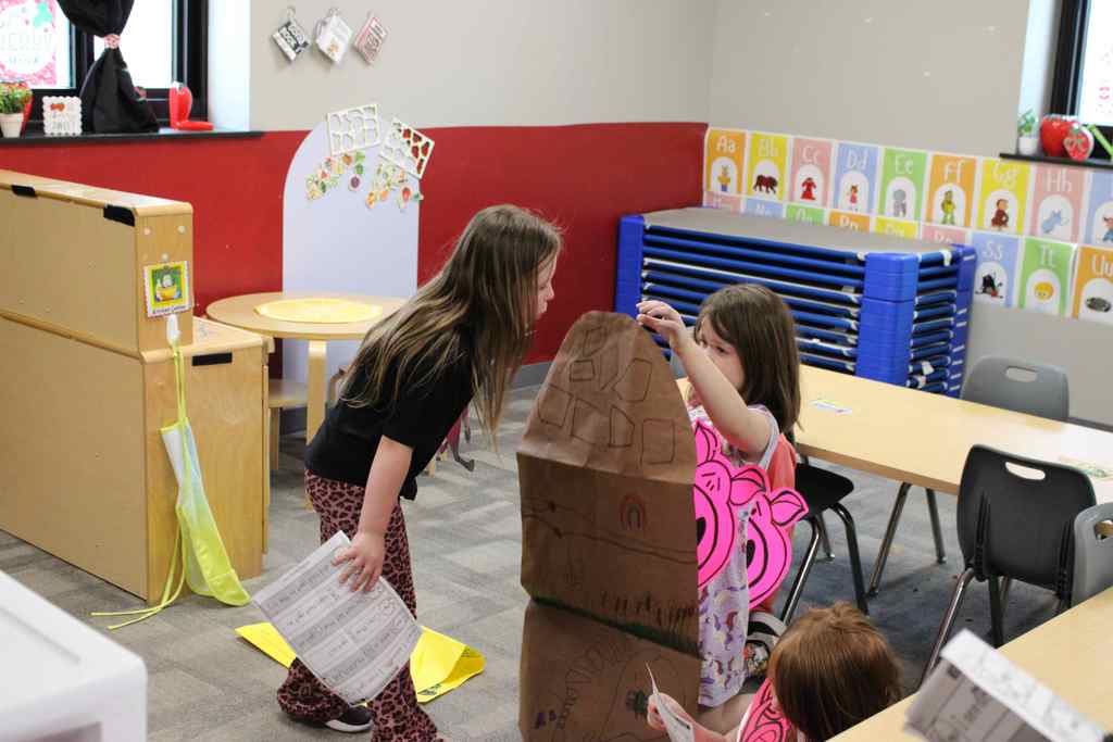 students mid play of the three little pigs 