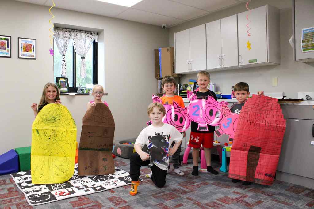 group of kindergarten students post play of 3 little pigs