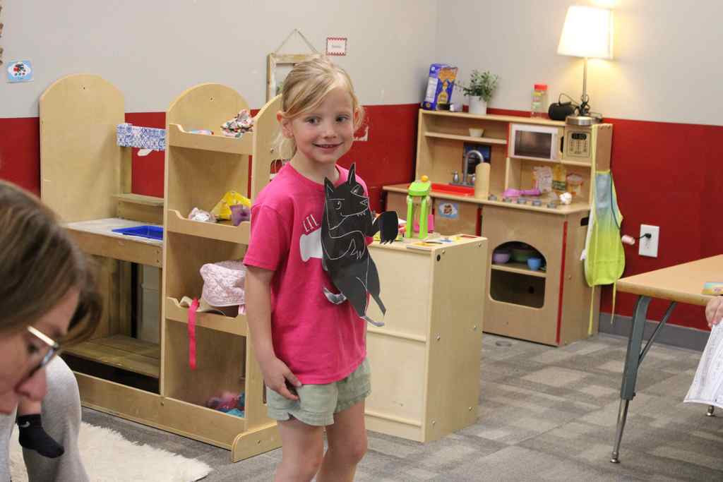 student smiling at the crowd. she is playing the wolf