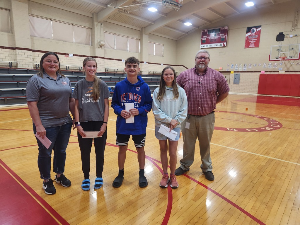 three students posing with two adults for their recent recognition for the 7th grade civics project