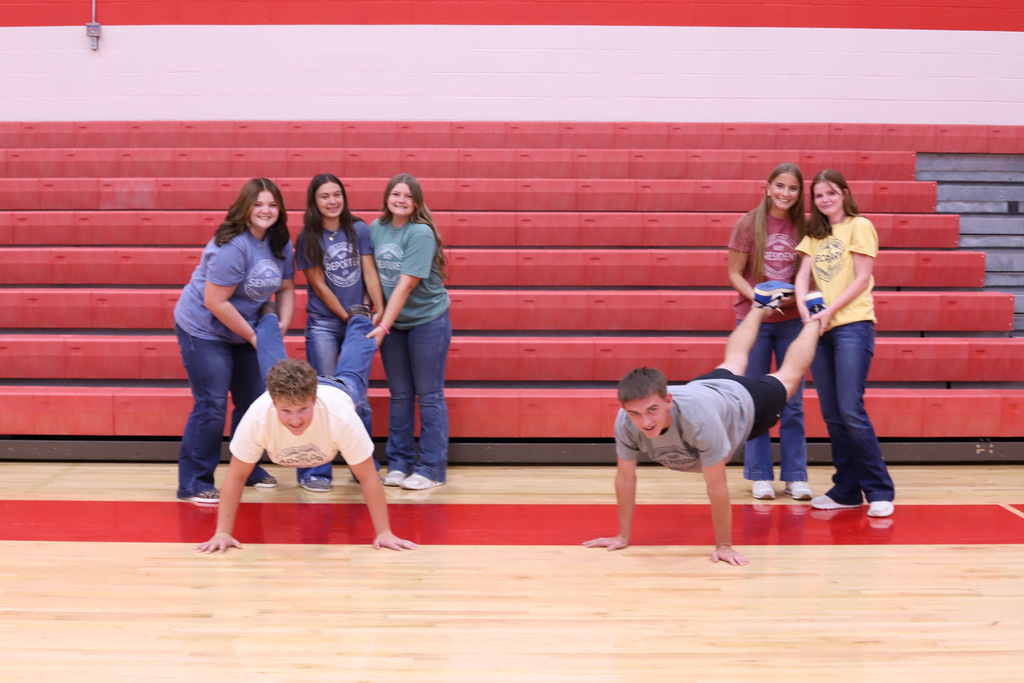 Class offiers playing around and carrying one person like a wheelbarrow