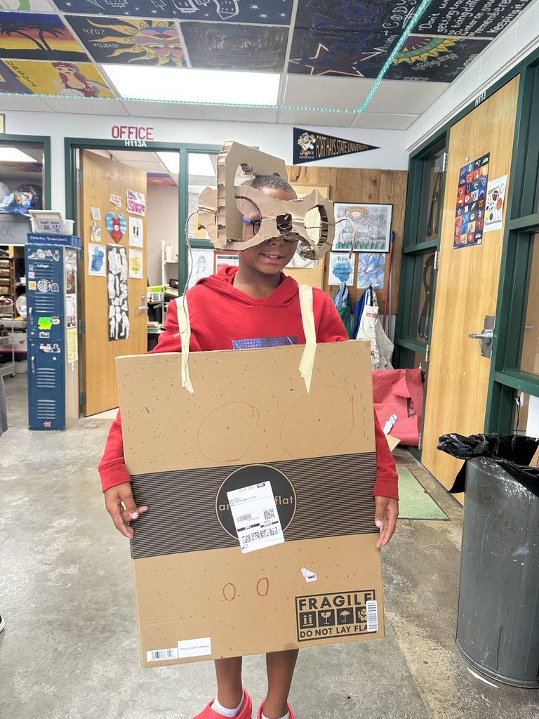 student showing off their handmade cardboard body suit