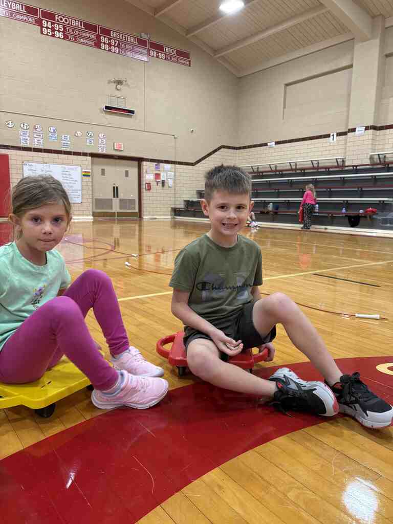 students having fun on scooters in pe