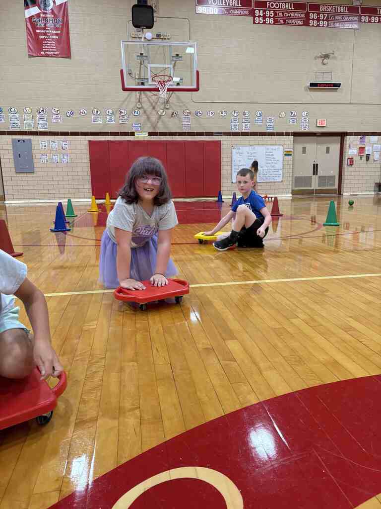 students having fun on scooters in pe
