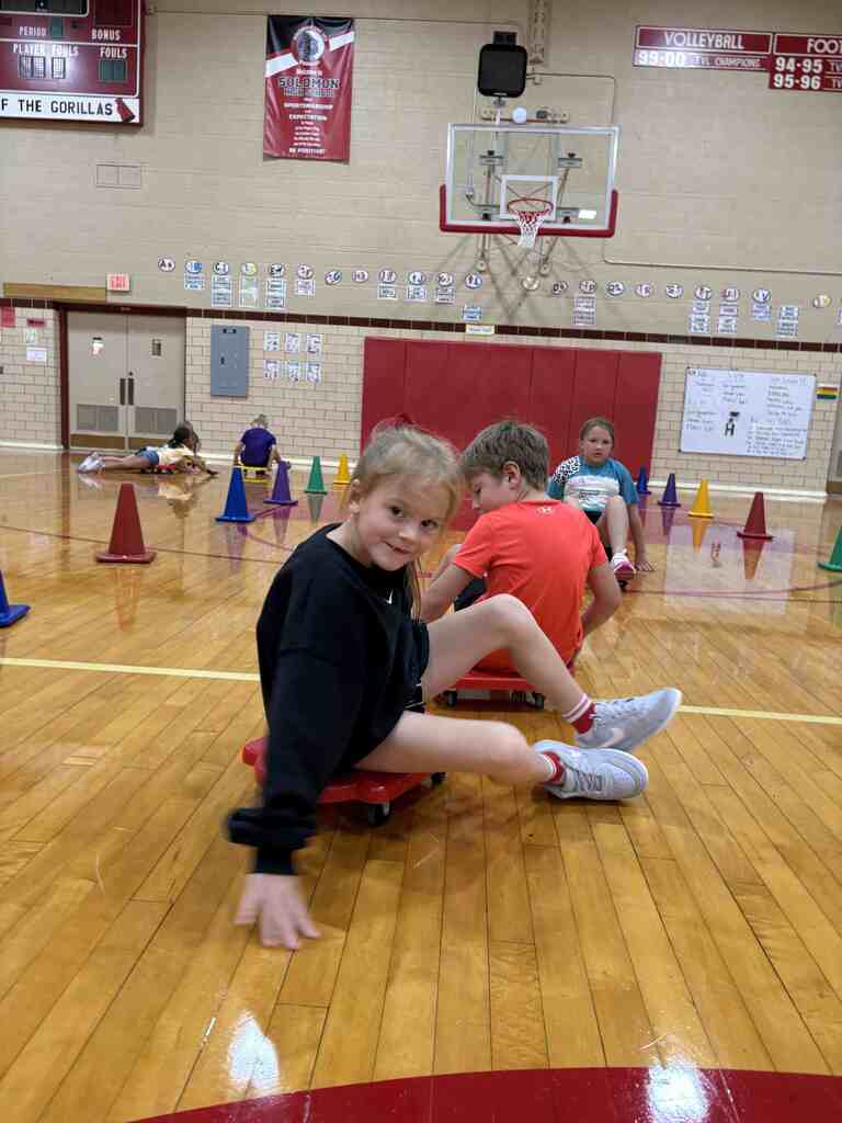 students having fun on scooters in pe