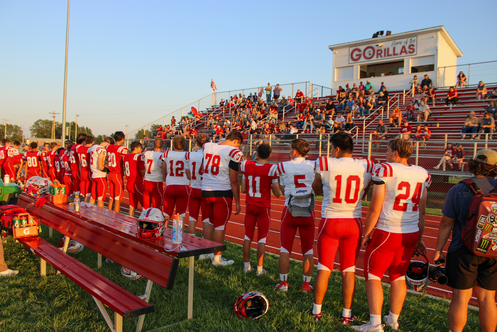 hs football players lined up in front of grandstand