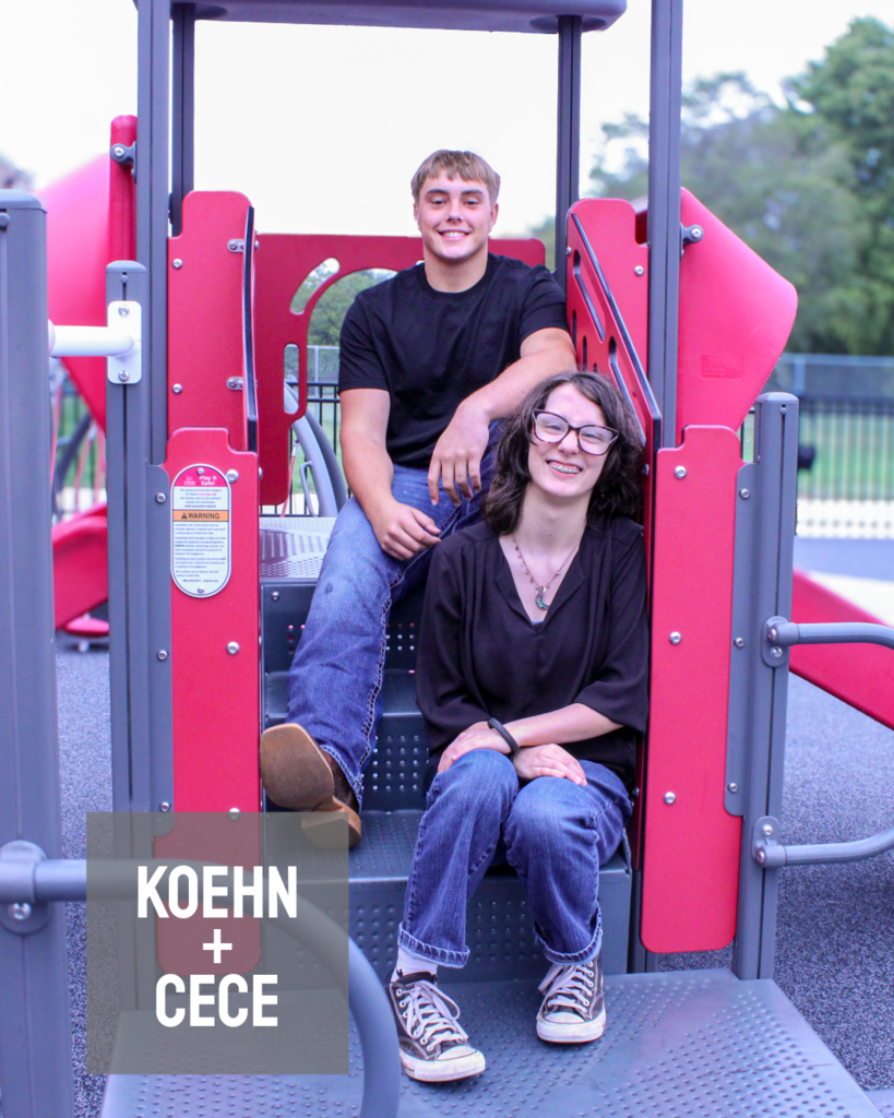 two homecoming candidates sitting elevated on a playground set