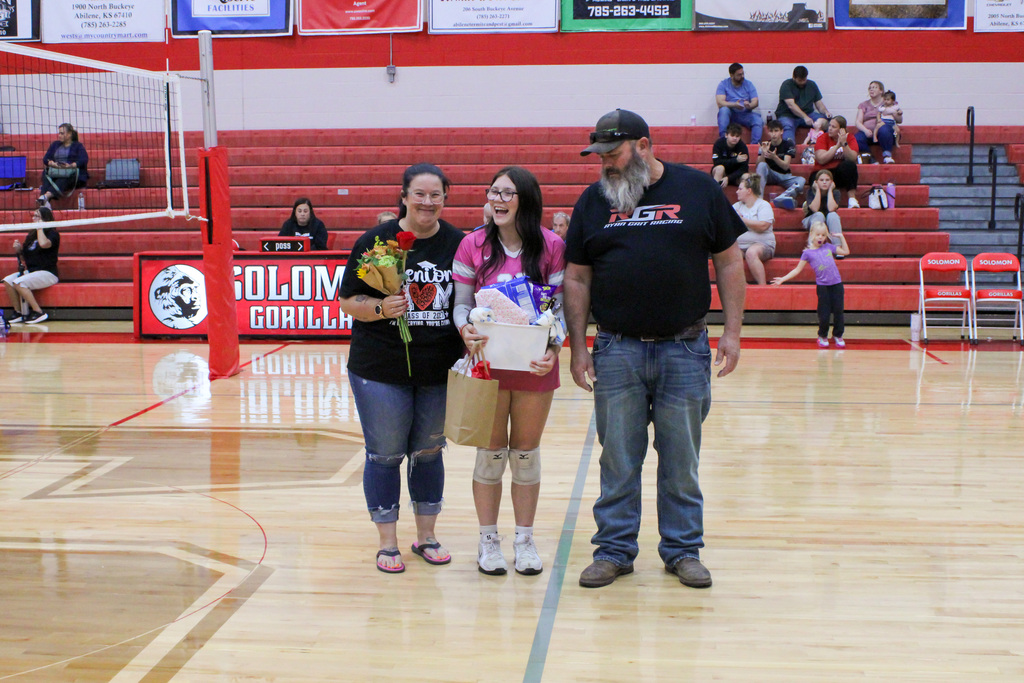 Student, Faith, and her parents on senior volleyball night