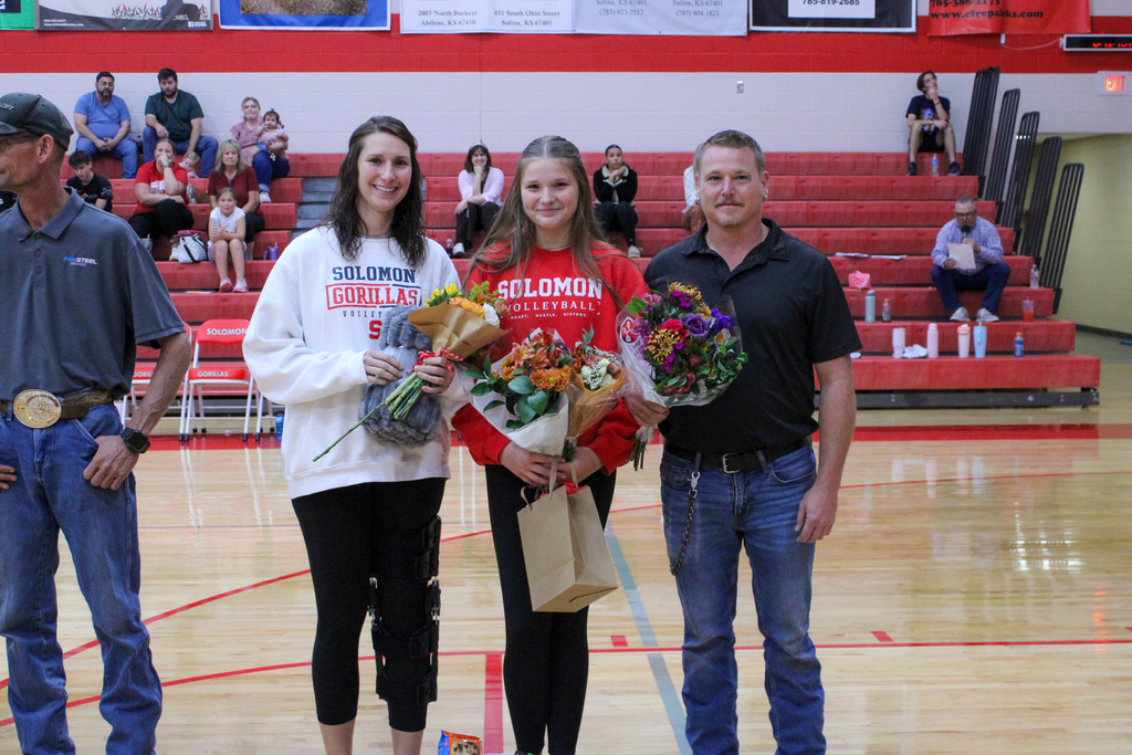 Student, Rylie, and her parents on volleyball senior night