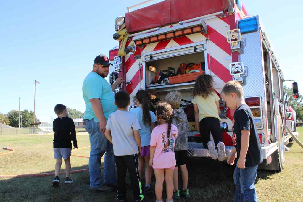 students listening to presentation about different items on a fire truck