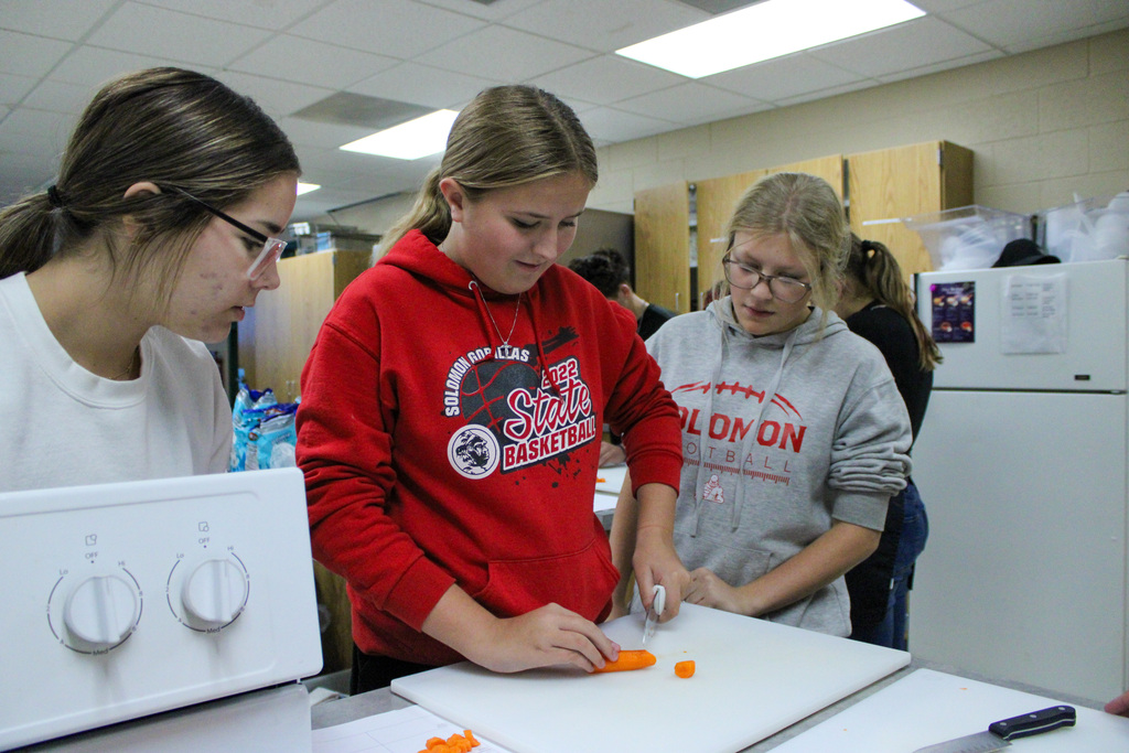 students practicing their cutting skills