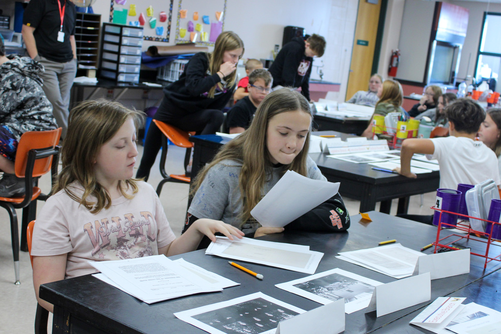 student reviewing Eisenhauer materials during presentation