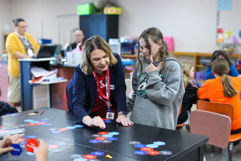 Leanne Holst helping a student with their puzzle