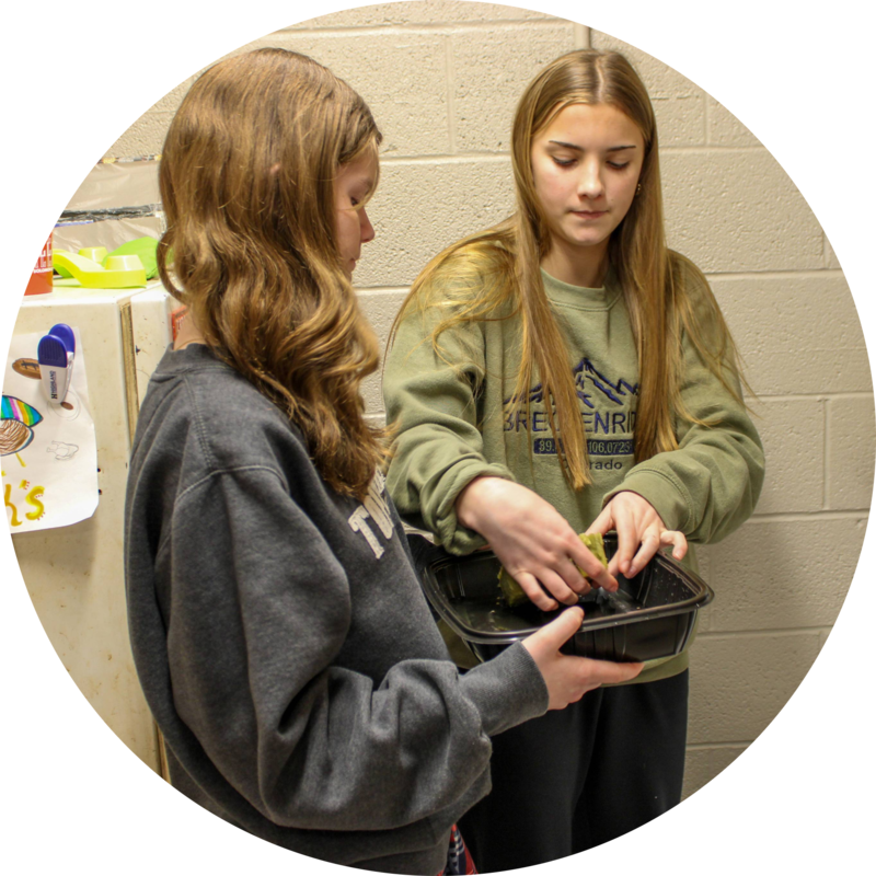 Myah placing seed and rock wool in hydorponics unit