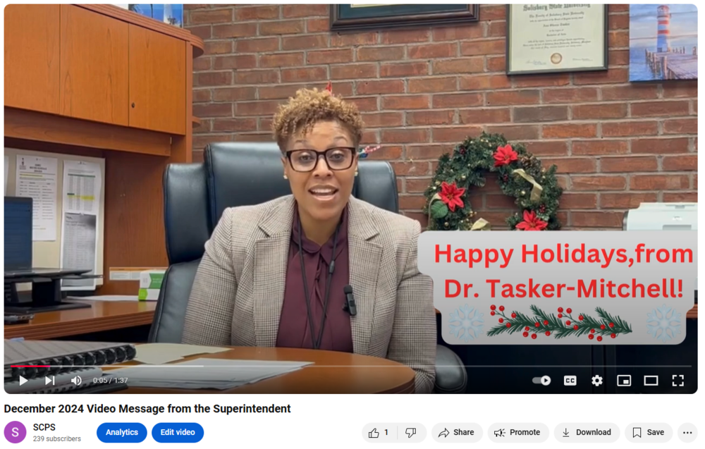 image of the superintendent at her desk and text that reads "happy holidays from Dr. Tasker-Mitchell