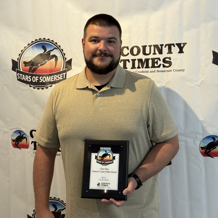 Man, smiling, holding a plaque