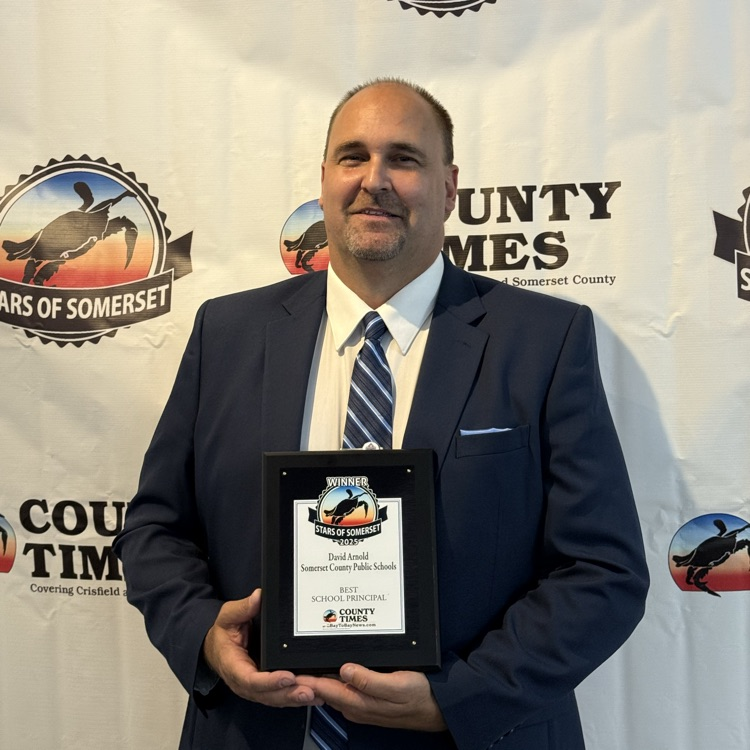 Man, smiling, holding a plaque