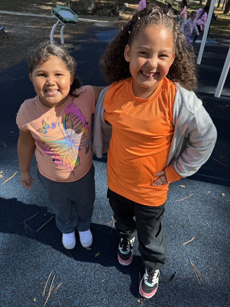 Two girls wearing orange