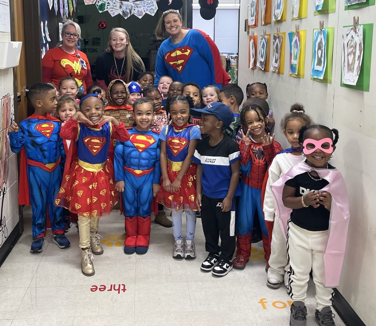 large group of teachers and students dressed as superheroes