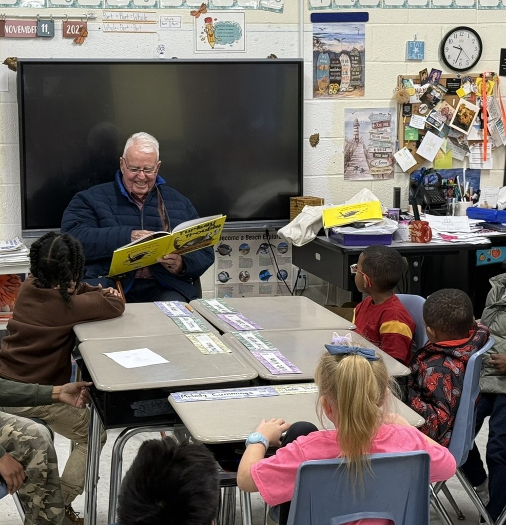 a veteran reading to children in a classroom