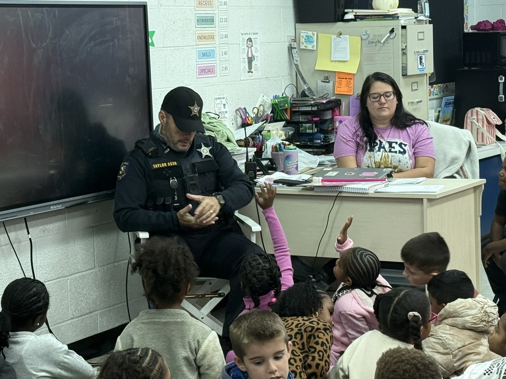 a veteran reading to children in a classroom