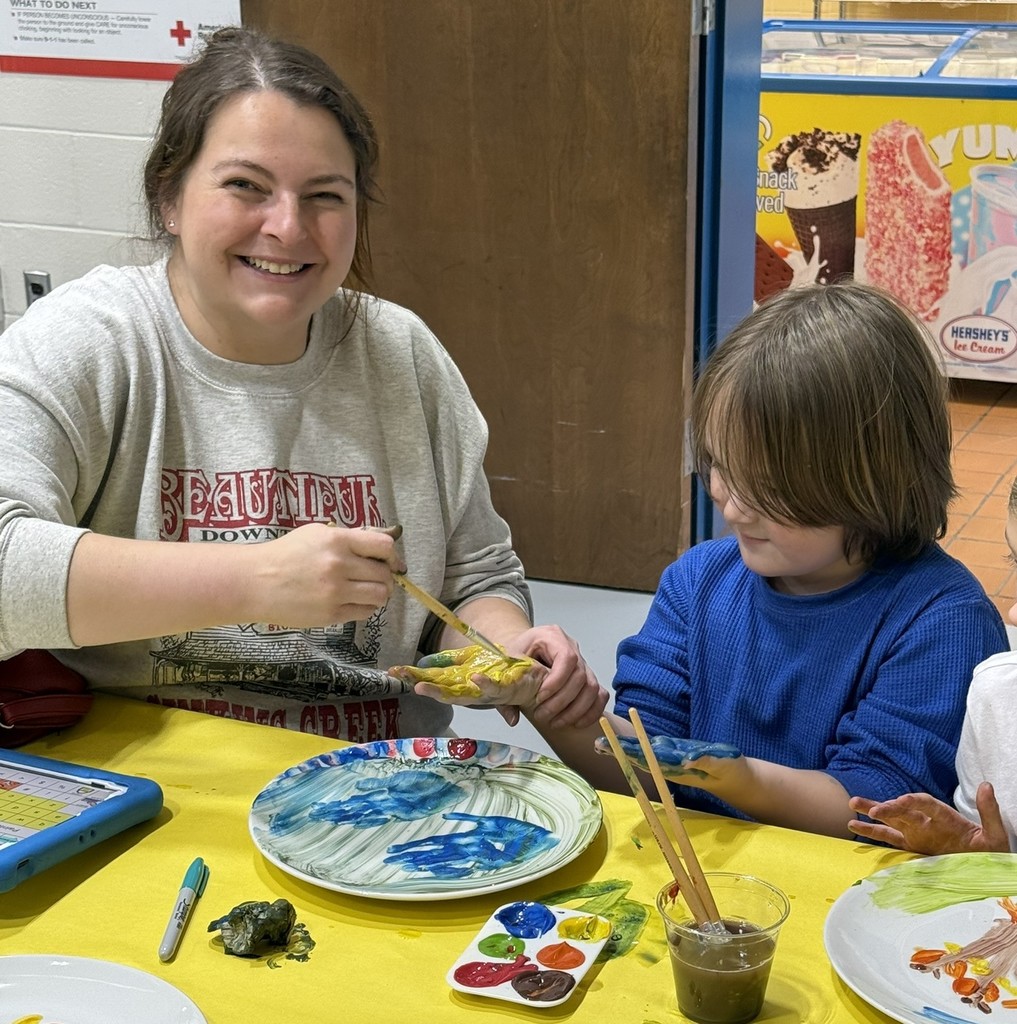 pictures of families enjoying a dinner plate painting craft at DIS' American Education Week Event